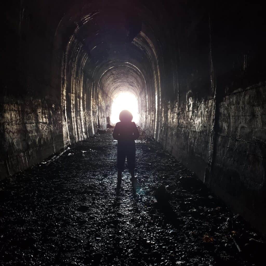 A woman standing in the abandoned train tunnel in Clinton Massachusetts.